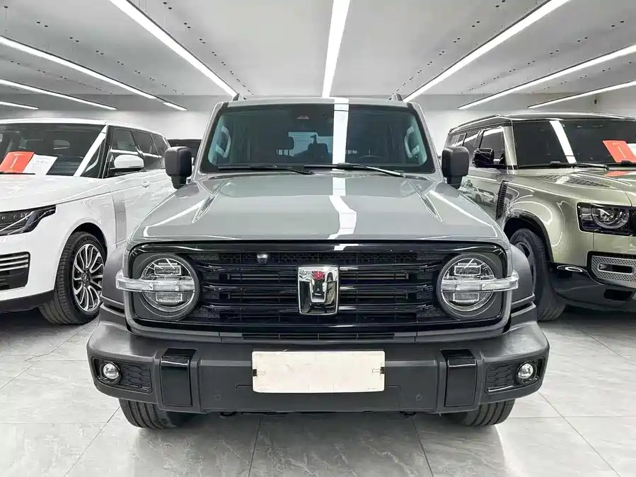 Representative grey-green 2024 GWM Tank 300 front view in a vehicle showroom
